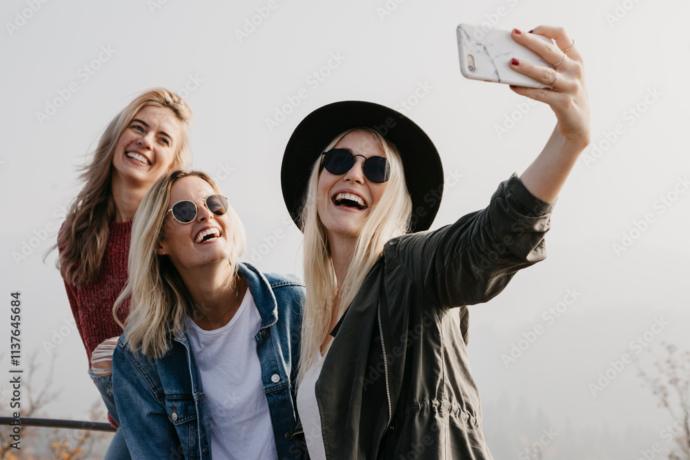 Three happy young women taking a selfie outdoors Three happy young women taking a selfie outdoors