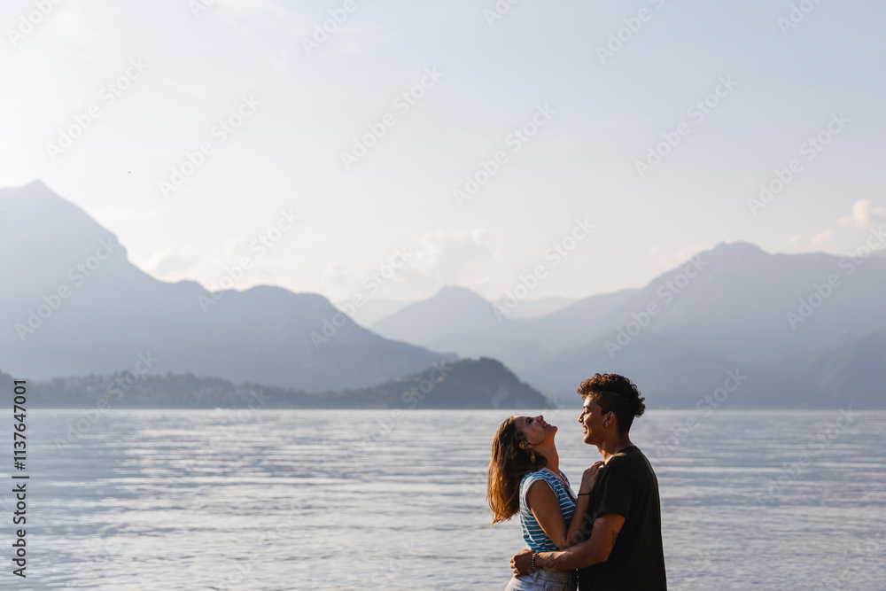 Happy affectionate young couple at the lakeside Happy affectionate young couple at the lakeside