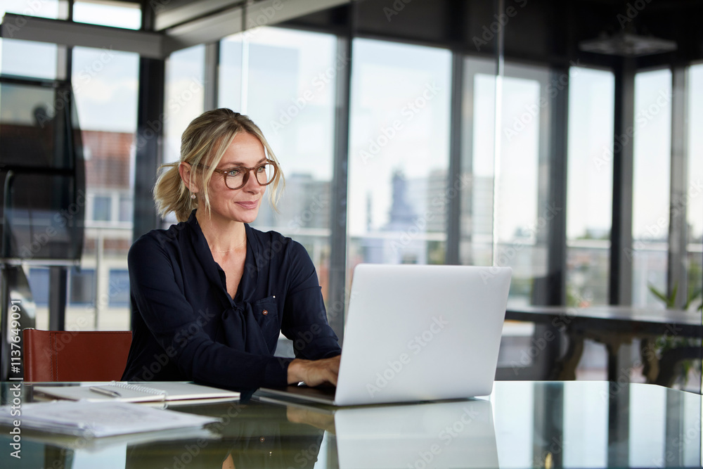 Businesswoman working in office, using laptop Businesswoman working in office, using laptop