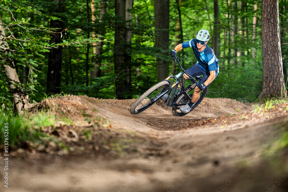 Athlete riding mountain bike in forest Athlete riding mountain bike in forest