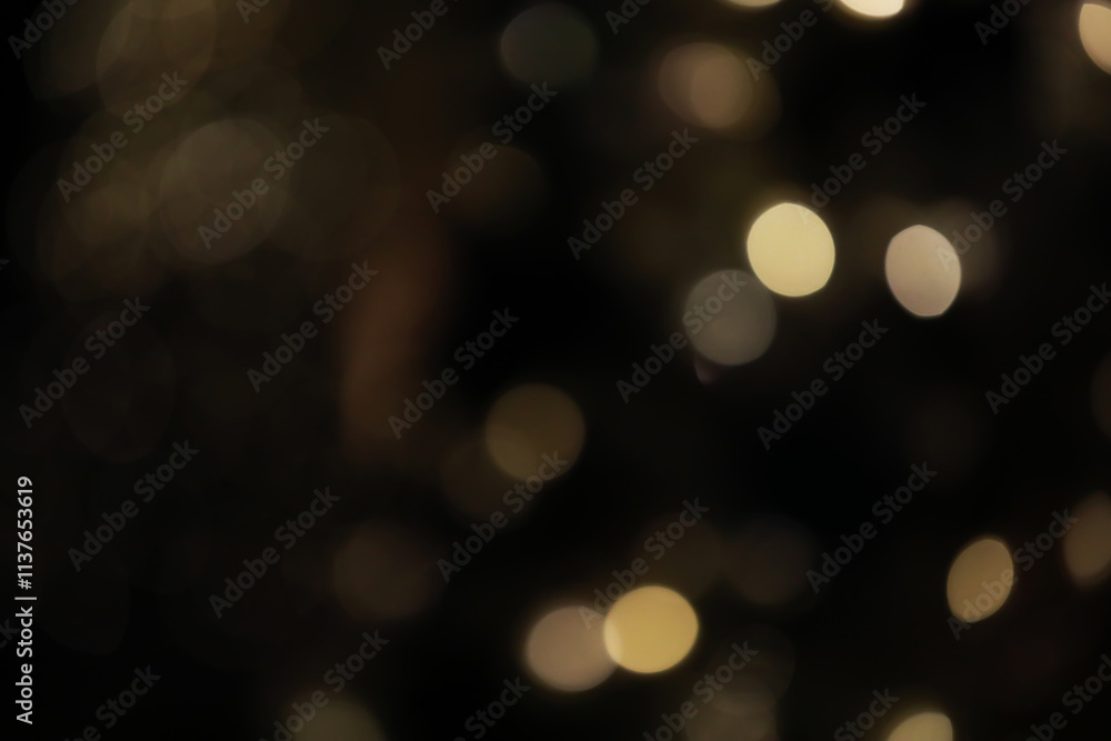 Obraz premium Defocused Warm Golden Bokeh Lights in a Soft Dark Background