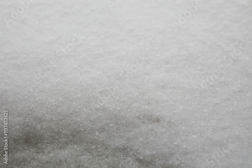 Close-Up of Snowy Surface with Light Frost Patterning and Texture Details