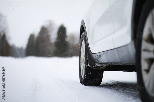 White Car Driving Through Snowy Landscape on Winter Day photo