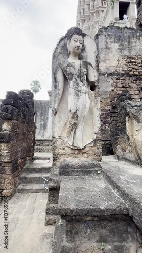 Sukhothai art Buddha statue at Wat Mahathat Cheliang, Sukhothai, Buddha statue in the Mara-Vijaya attitude and standing Buddha statue in the Leela attitude