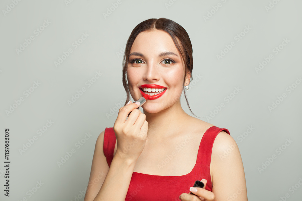 Happy emotional woman with bright make-up applying red lipstick, portrait Happy emotional woman with bright make-up applying red lipstick, portrait