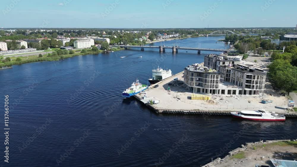 New building construction site on deep blue Parnu river in Estonia New building construction site on deep blue Parnu river in Estonia
