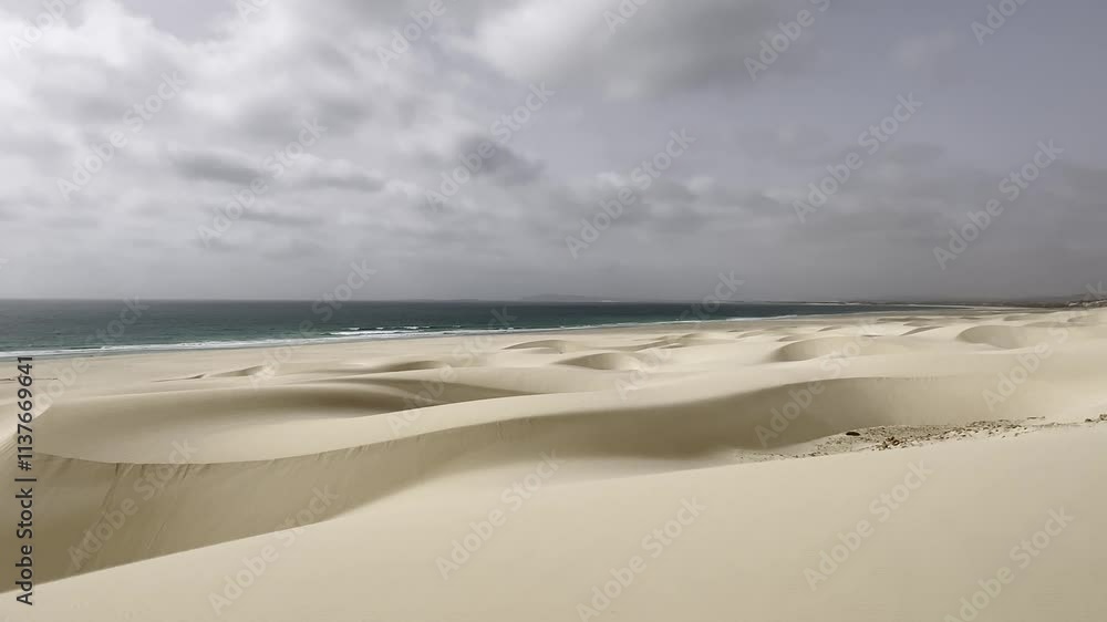 Golden sand dunes and empty coastline with no people, Praia de Chaves, Boa Vista, Cape Verde, under a dramatic cloudy sky Golden sand dunes and empty coastline with no people, Praia de Chaves, Boa Vista, Cape Verde, under a dramatic cloudy sky