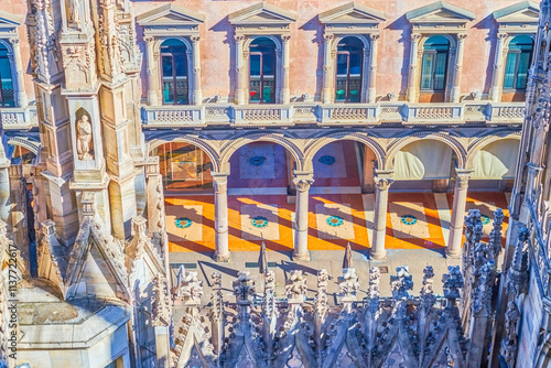 Decorative stonework and flying buttresses on the roof of Milan Cathedral, Italy photo