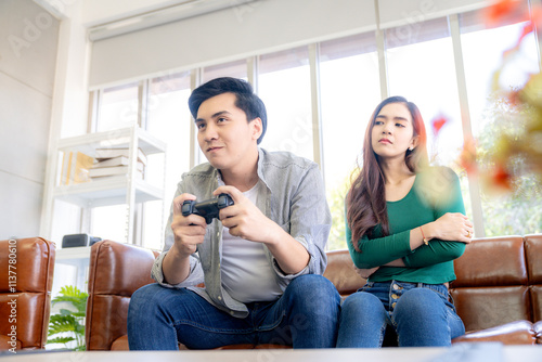 A young couple playing games together at home