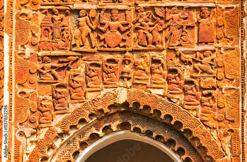 Lower panel carvings featuring Dashavatara and musicians on the facades of Radha Binod Temple, Joydev Kenduli, Birbhum, West Bengal, India. photo