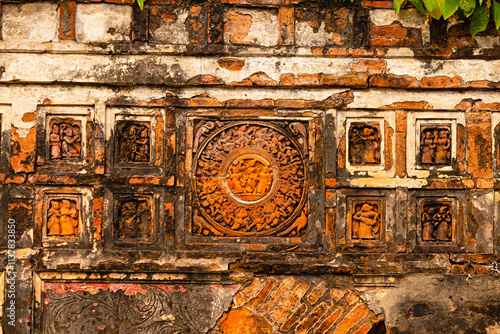 Exquisite terracotta carvings depicting scenes from Krishnaleela (Lord Krishna's life) on Raghunath Temple, Kuchut, Bardhaman, West Bengal, India. photo