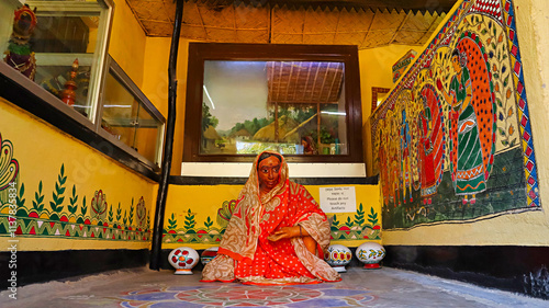 Statue of a tribal woman inside the Assam tribal hut exhibit at Srijani Shilpagram, Sriniketan, Bolpur, West Bengal, India. photo