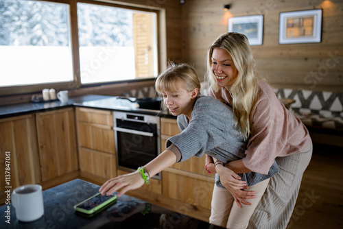 Mother doesn't want to allow her daughter to take the smartphone.