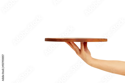 Man hand holding a brown round wooden tray on a blue background with copy space
