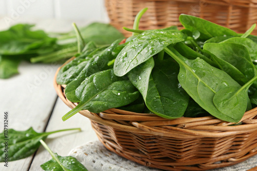 A freshly plucked spinach bunch in a woven basket