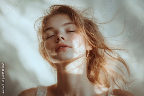 Young woman with closed eyes enjoys peaceful moment with soft light and gentle breeze outdoors