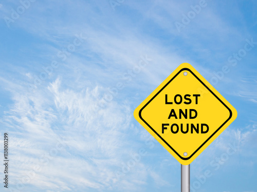 Yellow transportation sign with word lost and found on blue color sky background