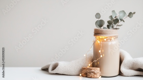 Cozy home decor with candle and eucalyptus in soft lighting