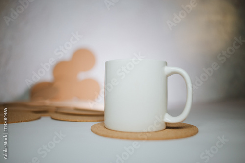 Wallpaper Mural White cup with cork coasters on a light background Torontodigital.ca