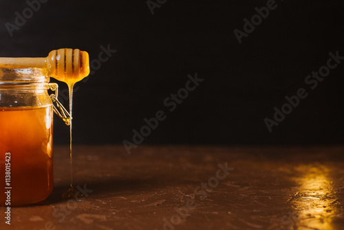 A jar of honey on a dark background