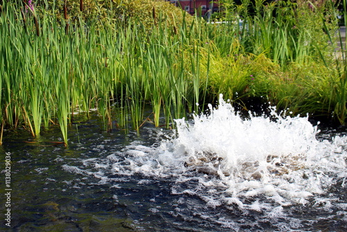 The fountain is like a small lake with splashes of water. photo