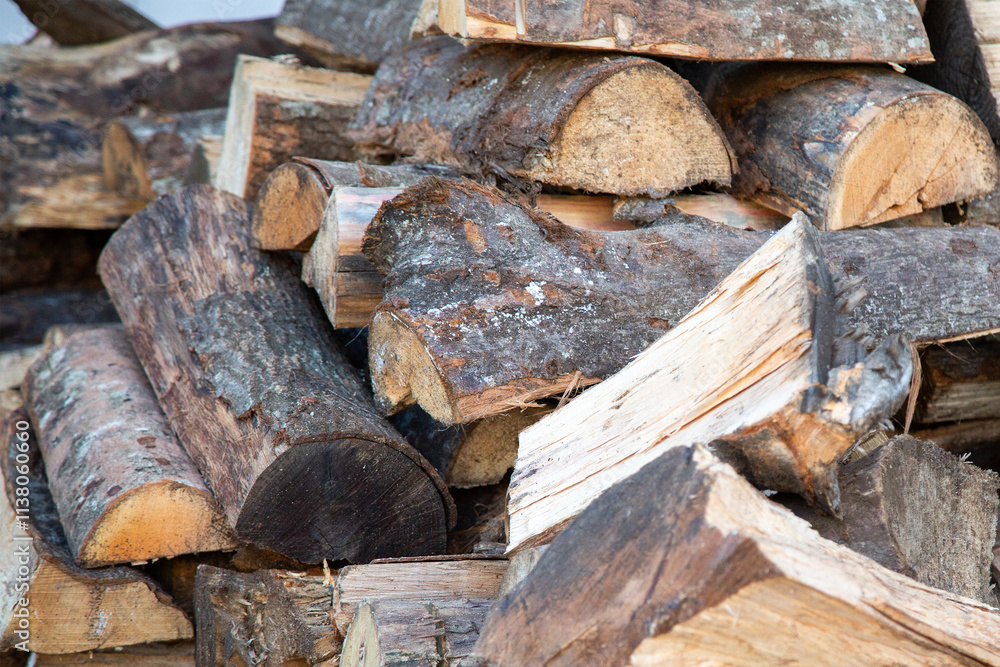 A large pile of logs stacked carefully on top of each other A large pile of logs stacked carefully on top of each other