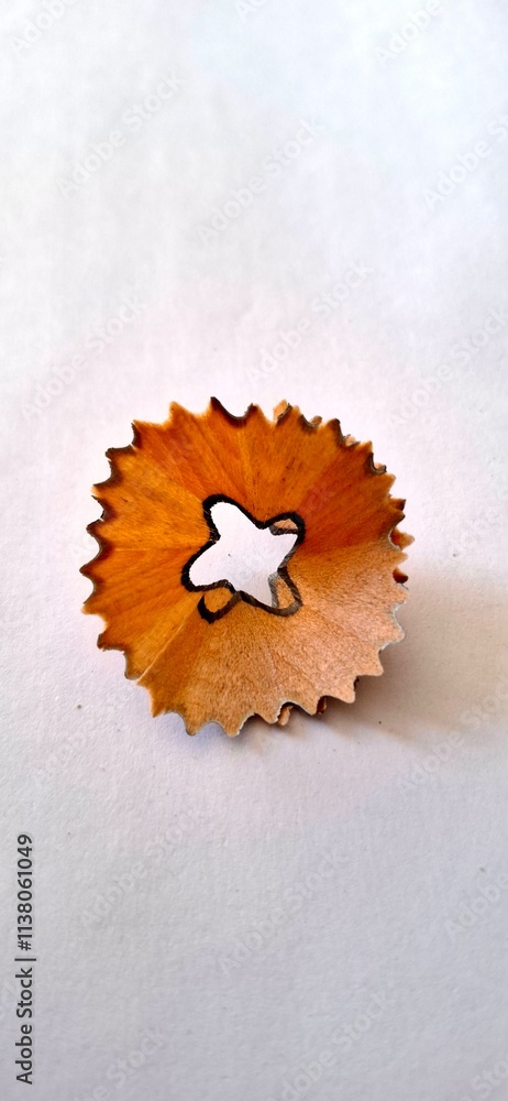 Pencil shaving round shaped debris after the sharpening of pencil by sharpener over the white background. Pencil shaving round shaped debris after the sharpening of pencil by sharpener over the white background.