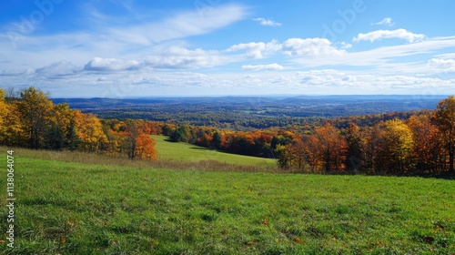 Scenic landscape of rolling hills and colorful autumn foliage under a clear blue sky capturing nature's beauty and tranquility.