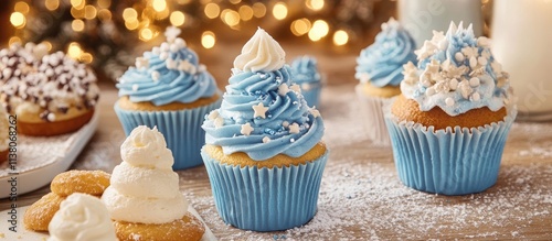 Delicious blue holiday cupcakes topped with whipped cream and festive decorations on a sweet dessert table setting photo