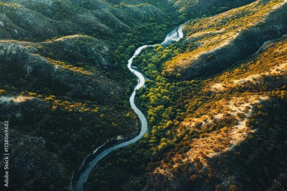 Winding river flows through the lush green valley surrounded by rolling hills during the golden hour of sunset Winding river flows through the lush green valley surrounded by rolling hills during the golden hour of sunset