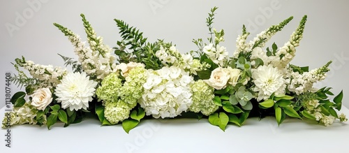 Elegant floral centerpiece arrangement with white and green blooms on a simple white background for event decoration and design inspiration. photo