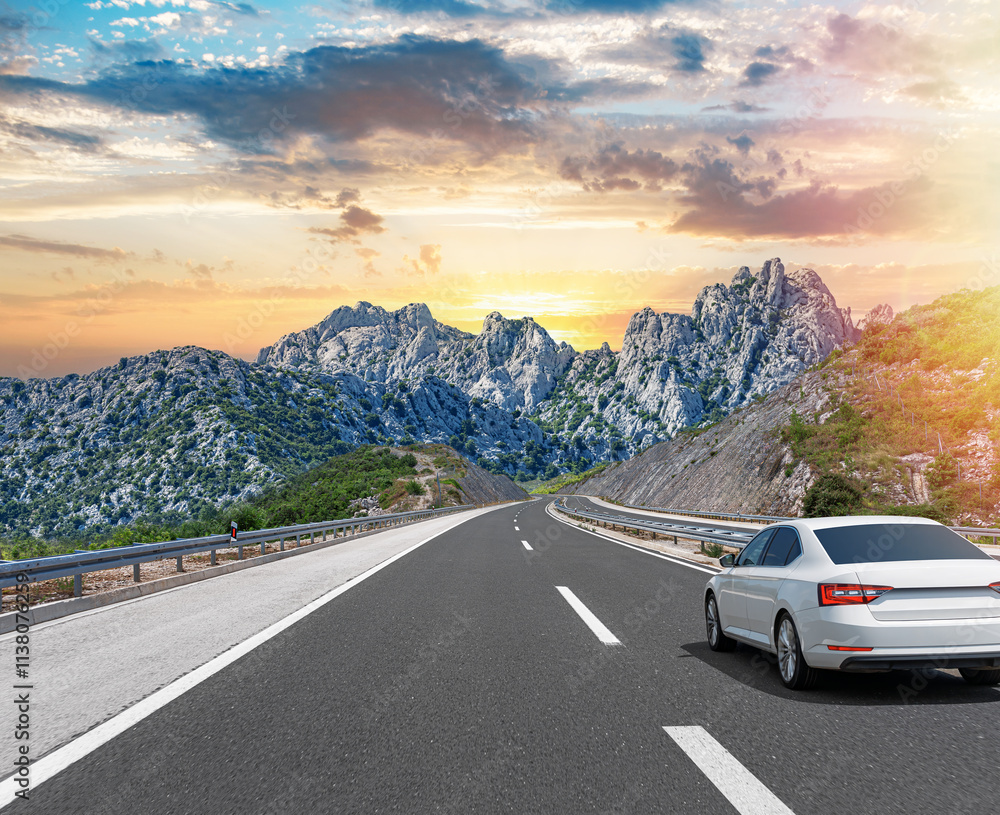 The car is driving along the highway surrounded by picturesque nature.