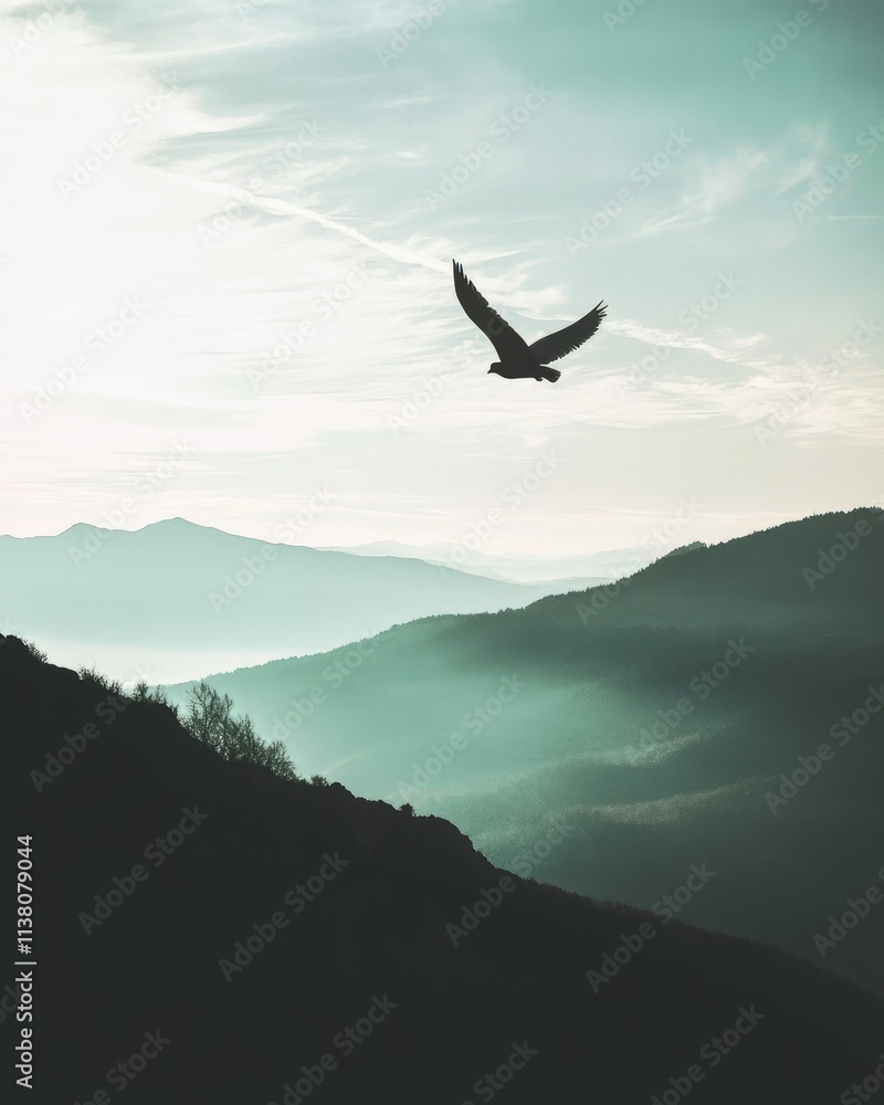 A silhouette of a bird soaring over misty mountains at dawn. A silhouette of a bird soaring over misty mountains at dawn.