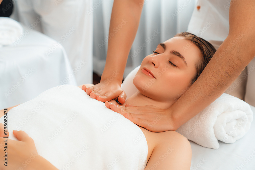 Caucasian couple customer enjoying relaxing anti-stress spa massage and pampering with beauty skin recreation leisure in day light ambient salon spa at luxury resort or hotel. Quiescent Caucasian couple customer enjoying relaxing anti-stress spa massage and pampering with beauty skin recreation leisure in day light ambient salon spa at luxury resort or hotel. Quiescent