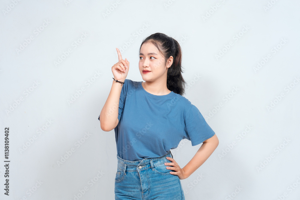 Excited Asian woman pointing at the copy space beside her, isolated on white background Excited Asian woman pointing at the copy space beside her, isolated on white background