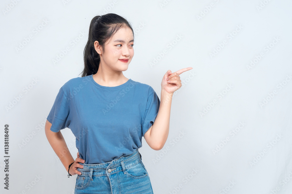 Excited Asian woman pointing at the copy space beside her, isolated on white background Excited Asian woman pointing at the copy space beside her, isolated on white background