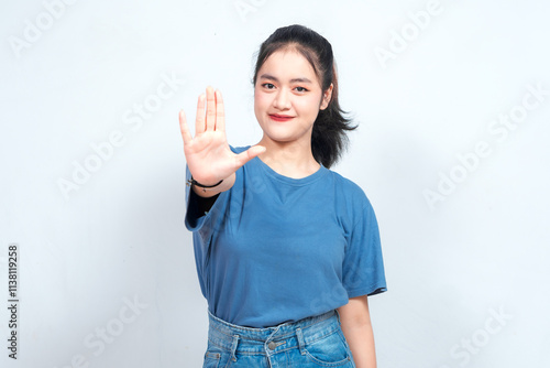 Stop. Concerned Asian woman showing refusal sign, saying no, raise awareness, standing over white background photo