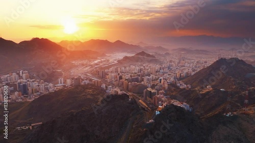 Aerial time lapse view showing crowds of pilgrims gathered around the Kaaba in the Grand Mosque, with construction cranes surrounding the site in Mecca (Makkah)