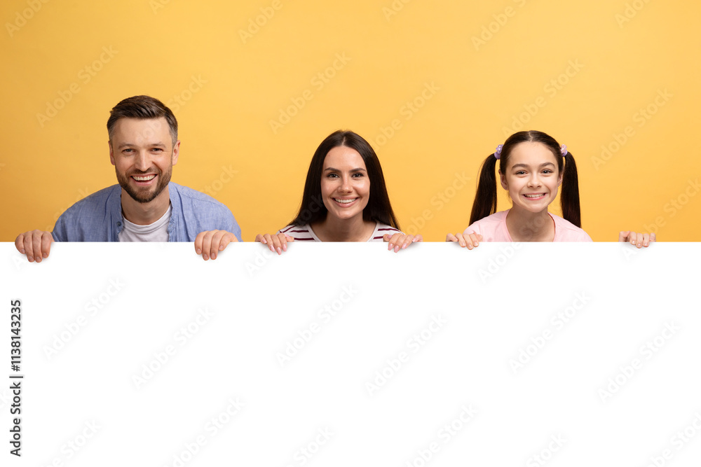 A loving family of three shares a joyful moment against a vibrant yellow backdrop, holding a blank sign. The father, mother, and daughter display warm smiles, embodying affection and connection. A loving family of three shares a joyful moment against a vibrant yellow backdrop, holding a blank sign. The father, mother, and daughter display warm smiles, embodying affection and connection.