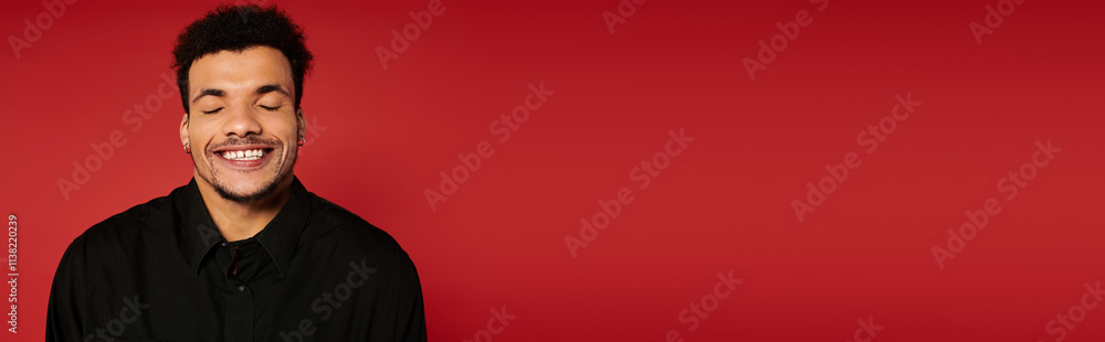 A young handsome man expresses joy with a broad smile, showcasing happiness and confidence. A young handsome man expresses joy with a broad smile, showcasing happiness and confidence.