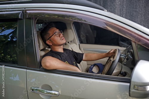 Young Asian male driver sleepy while driving, dangerous traffic accident insurance concept photo