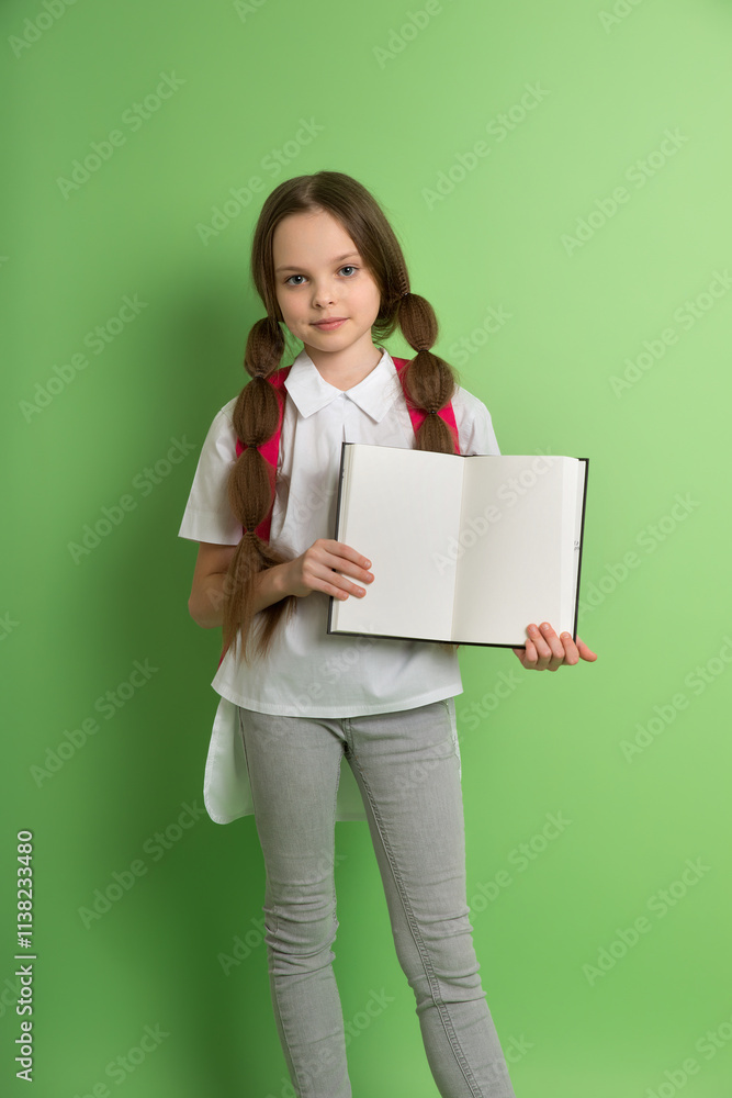 Happy teenager student girl is holding book with clean page. Smiling schoolgirl with book. Concept of education, reading, back to schoo Happy teenager student girl is holding book with clean page. Smiling schoolgirl with book. Concept of education, reading, back to schoo