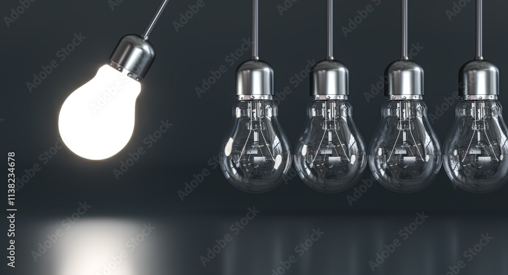 Lit light bulb swinging and transferring energy to other Lit light bulb swinging and transferring energy to other