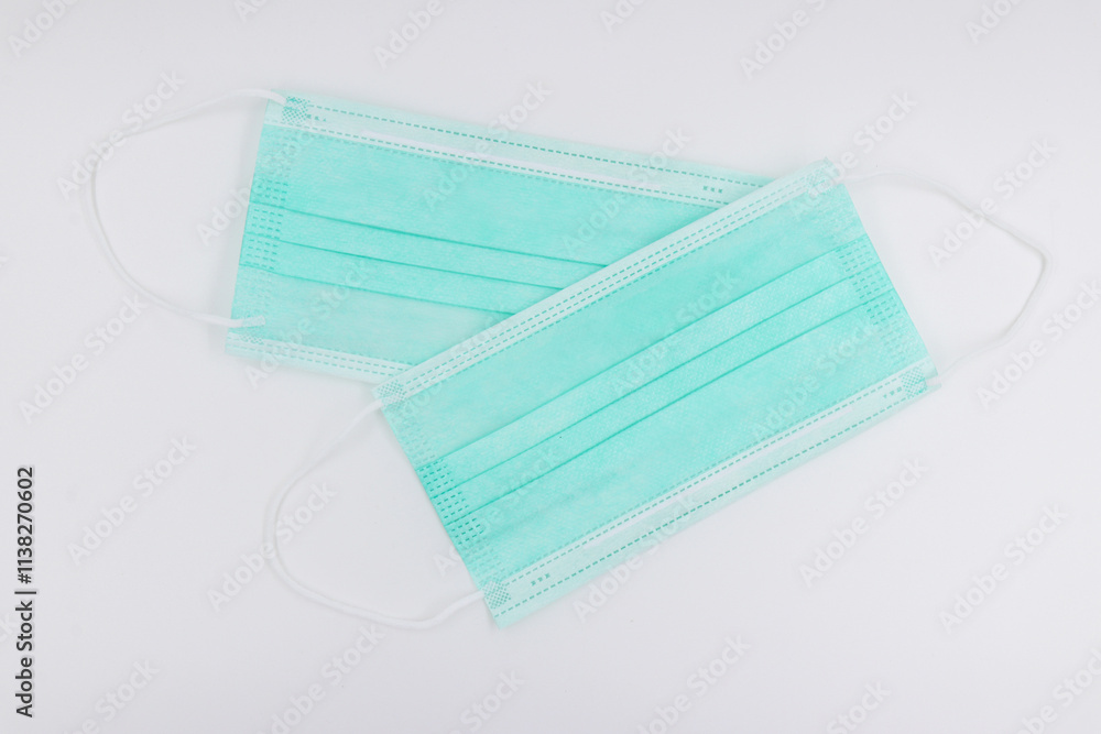 Green medical mask on white background. Prevent the coronavirus. Green medical mask on white background. Prevent the coronavirus.