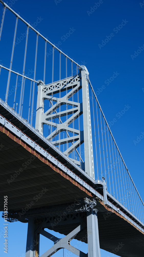 The Ben Franklin Bridge built in 1926 spanning between Philadelphia PA and Camden New Jersey on a beautiful blue sky afternoon The Ben Franklin Bridge built in 1926 spanning between Philadelphia PA and Camden New Jersey on a beautiful blue sky afternoon