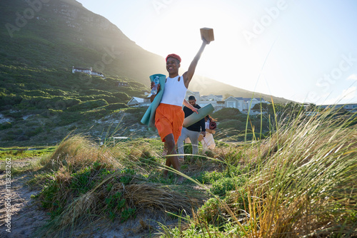 Friends with yoga mats on footpath photo