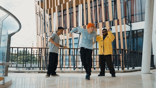 Hip hop team dance break dance while multicultural friend surrounded and clapping hands to cheer or encourage his friend to dance. Active and energetic street dance. Outdoor sport 2024. Hiphop. photo