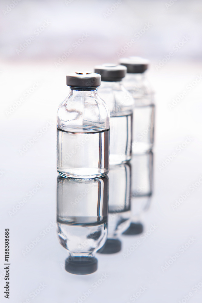 Set of transparent medical glass bottles of liquid Set of transparent medical glass bottles of liquid