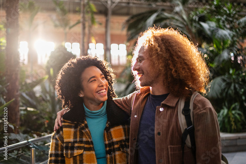 Happy tourist couple walking and smiling in atocha train station, madrid