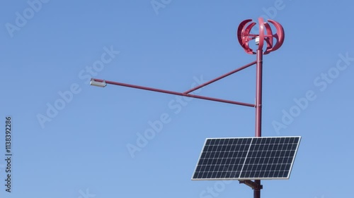 compact local red windmill with solar panel to provide electricity and power generation for lantern